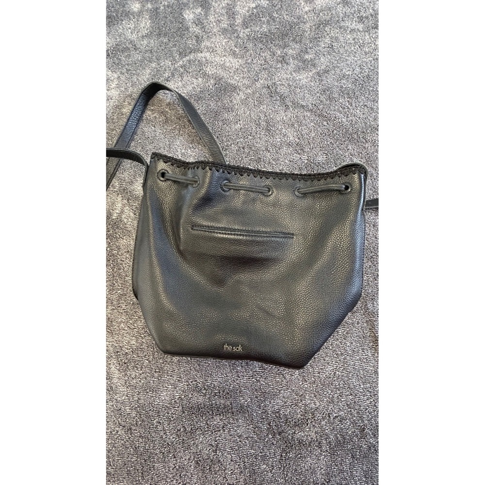 The Sak Black Pebbled Leather Crochet Trim Drawstring Crossbody Bucket Bag
